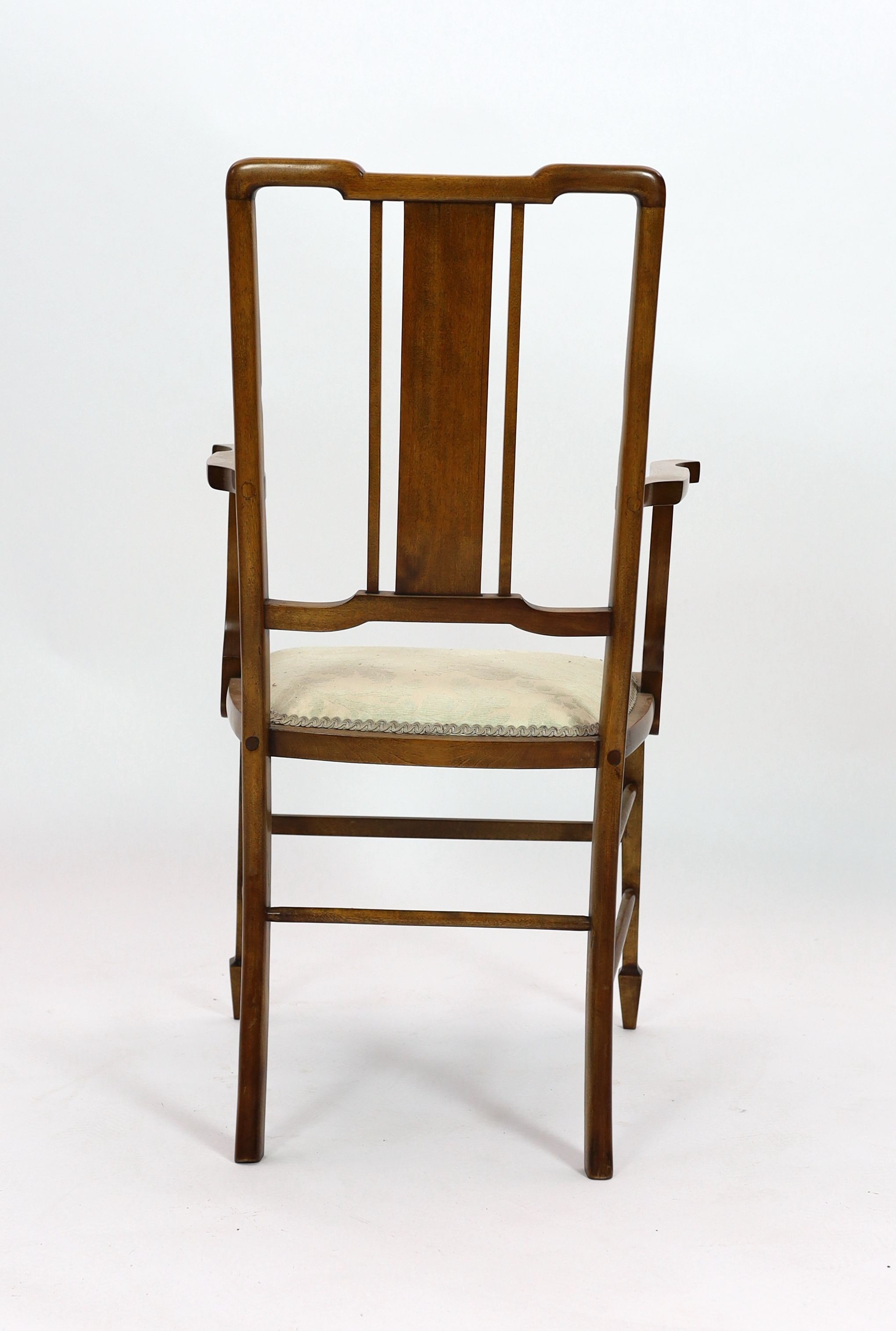 An Edwardian inlaid mahogany elbow chair, width 51cm depth 45cm height 96cm, and two Edwardian dining chairs